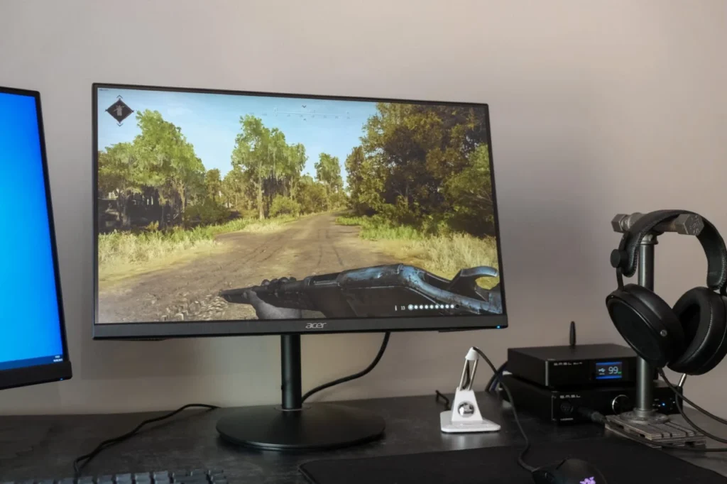 Acer XV252QF review - a monitor on a desk with a second monitor